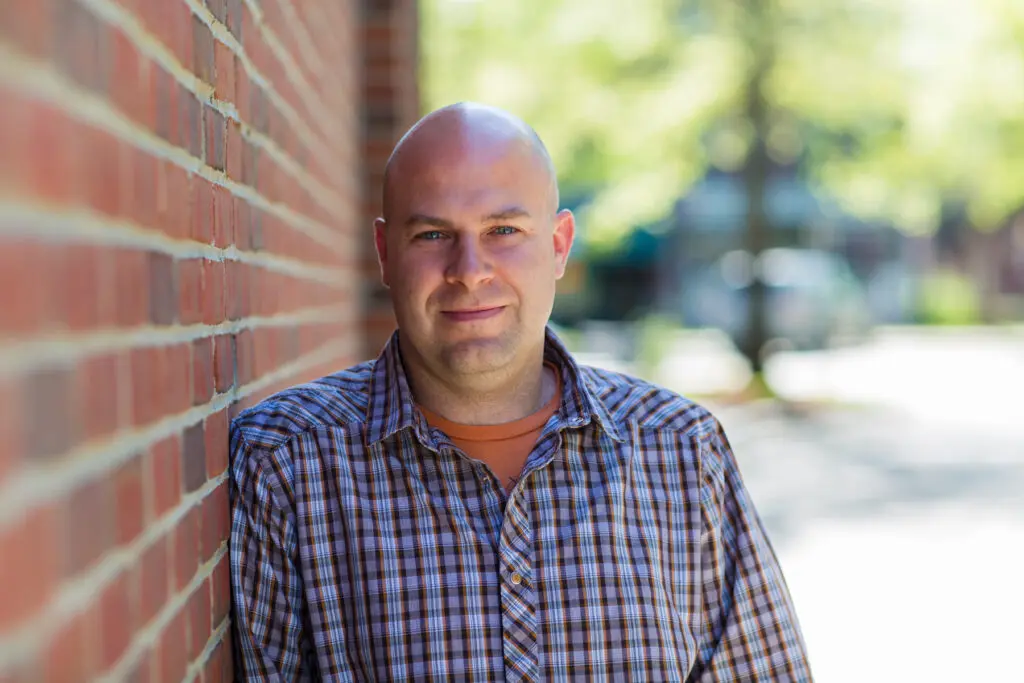 Zach Luse Headshot Brick Wall